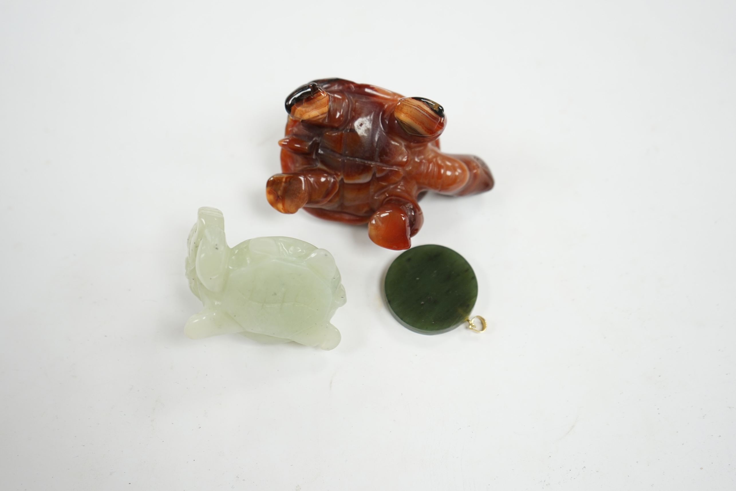 A Chinese carved bowenite dragon, an agate tortoise and a hardstone green circular pendant disc, largest 8cm long. Condition - good